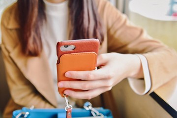 Woman Holding Her Smartphone in a Cafe