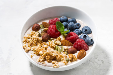 muesli with yogurt and berries for breakfast on white table