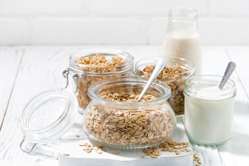 oat flakes and assortment of muesli, milk and yogurt