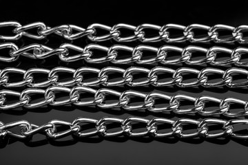 Chain heap - abstract metal background. Collection silver jewelry chains on an isolated black...