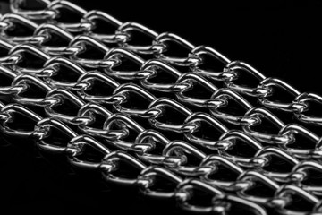 Chain heap - abstract metal background. Collection silver jewelry chains on an isolated black...