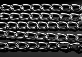 Chain heap - abstract metal background. Collection silver jewelry chains on an isolated black...
