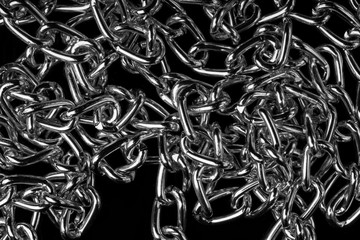 Chain heap - abstract metal background. Collection silver jewelry chains on an isolated black background. Set of different lenght metal chain. Accessories. Bijouterie. Silver.