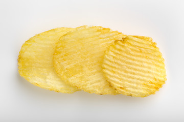Crispy potato chips. Fast Food. Potatoes. Fatty unhealthy foods. corrugated chips