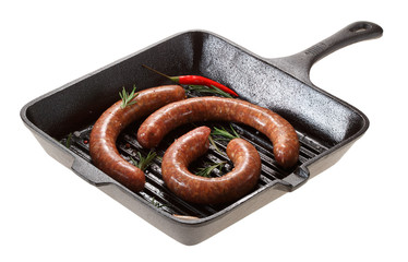 Raw homemade sausage for grilling in the pan. Isolated on white background.