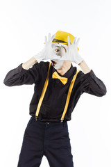 Portrait of a man, artist,clown, MIME. Shows a heart isolated on white background.