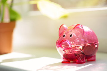 house savings - piggy bank on window sill
