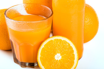 Orange juice. Isolated drink. A glass of orange juice and pieces of orange fruit isolated on white background. Citrus. Diet. Vitamins. Healthy food.