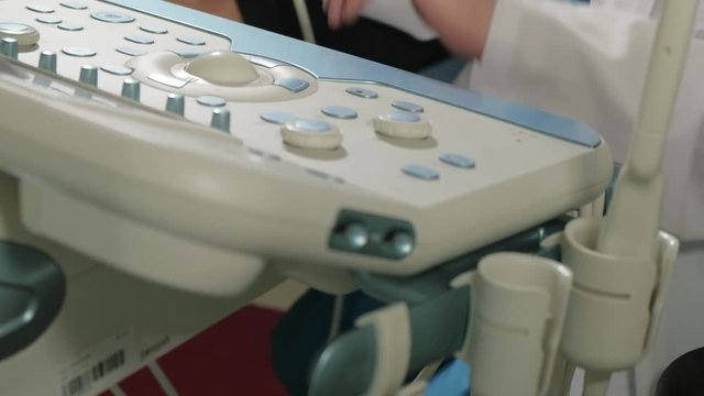 Doctor doing 3d ultrasound on belly of t woman in clinic 4k