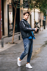 Confident and handsome young man in the street