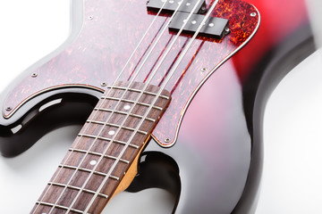 Metallic volume treble guitar bass knobs. Electric guitar. Red electric bass guitar close-up. Musical instrument. Music. Four strings. Grif.