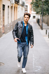 Confident and handsome young man in the street