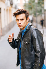 Confident and handsome young man in the street