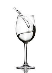 A splash of crystal clear water in a glass for wine. Water splashes. Drinking water. Alcohol.