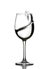 A splash of crystal clear water in a glass for wine. Water splashes. Drinking water. Alcohol.