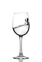 A splash of crystal clear water in a glass for wine. Water splashes. Drinking water. Alcohol.