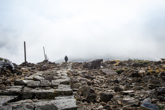 One person hiking to the peak of Mount Kumanodake - Stock image