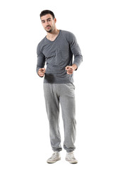 Fototapeta premium Happy young fit sporty athletic man pointing finger choosing you. Full body length portrait isolated on white studio background. 