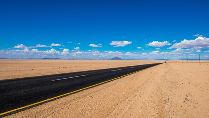 vibrant image of highway and blue cloudy sky