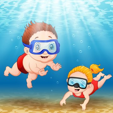 Two kids diving underwater 
