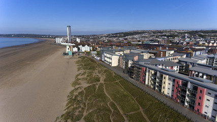 Fototapeta na wymiar Editorial SWANSEA, UK - APRIL 19, 2017: An aerial view of the new coastal housing and the Meridian Tower at the marina sea front area of Swansea Bay, South Wales 