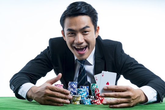 The poker gambler showing a pair of aces and hold bet a large stack with arms
