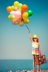 Child with vintage suitcase on summer vacation