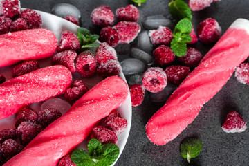 Ice cream pops with iced raspberry fruits
