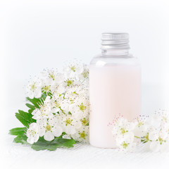 Fototapeta na wymiar a bottle of natural baby cosmetic with flowers