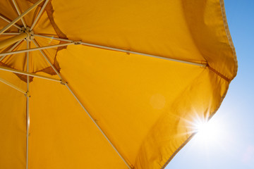 Yellow umbrella and rays of sun