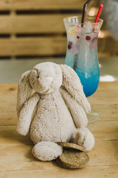 Blue Italian Soda, Signature Mocktail drink for Children birthday party, with rabbit soft plush on the table. Concept of birthday party and birthday baverages for kids