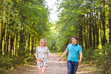 Fototapeta premium Happy beautiful pregnant woman and her husband