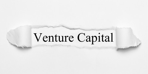 Venture Capital on white torn paper