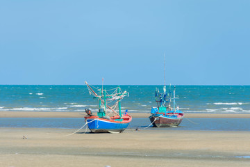 Fototapeta premium boat of fisherman on the sea beach with blue sky at sunny day.