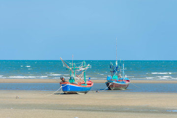boat of fisherman on the sea beach with blue sky at sunny day.