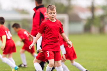 Obraz premium Kids soccer football - children players exercising before match on soccer field