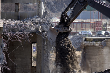 Excavator with shovel full og gravel and soil