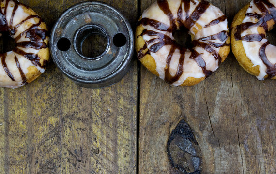 Retro donut cutter with donuts close up on rustic wood table