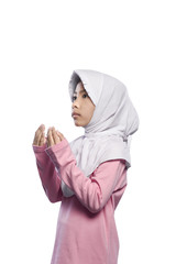 Asian muslim girl wearing veil and praying to god