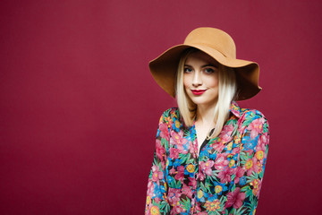 Beauty Portrait of Amazing Blonde in Hat and Colorful Shirt Posing on Pink Background. Studio Short of Cute Young Woman.