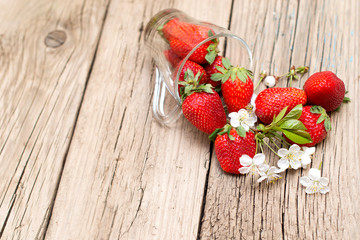 Fresh strawberries on old wooden table  