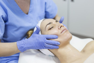 Naklejka premium Cosmetic treatments for the skin in the beauty salon. Woman in spa salon