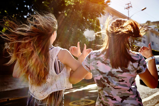 Teenage girls having fun in residential street, Cape Town, South Africa
