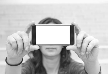 Woman holding modern smartphone. Horizontal mockup. Replaceable with own design. Landscape mode, 16:9 aspect ratio.Top view.