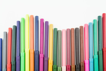 Row of colorful color pen on white background