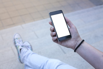 Woman holding modern smartphone. Horizontal mockup. Replaceable with own design. Portrait mode,...