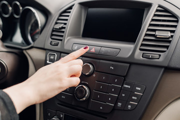 Female finger hitting car emergency light botton, woman pressing red triangle car hazard warning button, Warning of the danger and stop