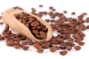 coffee beans in a wooden scoop isolated on white background