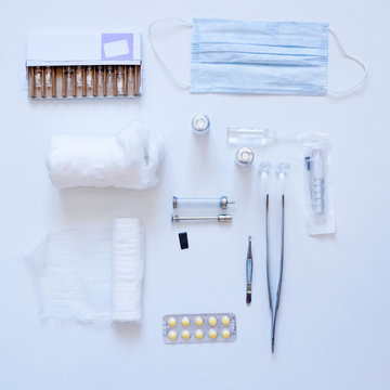 Overhead view of medical equipment and drugs on white background