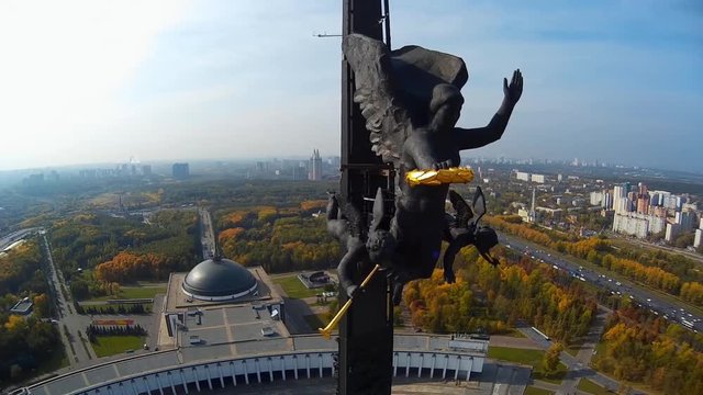 Poklonnaya Hill. Victory Park obelisk  with a statue of Nike and a monument of St George slaying the dragon. Moscow city Russia. Unique view city. Summer sunny day. Aerial Fly around  close to